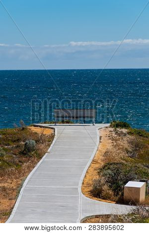 Bench Looking Outwards To The Ocean At A Scenic Lookout At Dynamite Bay In Green Head, Western Austr