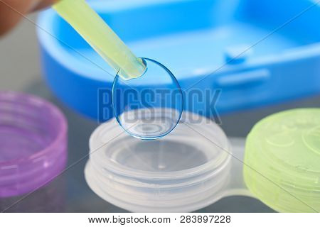 Silicon Hydrogel Contact Lens Picked Up With Tweezers From Lens Case