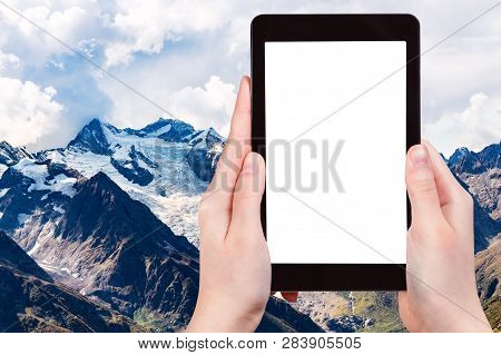 Travel Concept - Tourist Photographs Of Snow-covered Mountain Tops From Moussa-achitara Mount In Dom