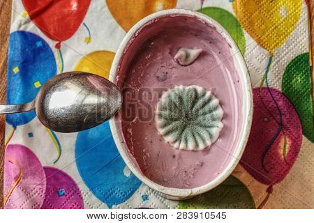 Moldy Uneatable Spoiled Children Food. Rotten Opened Cup Of Cream With Stainles Spoon.