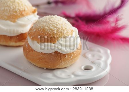 Fastelavn buns on a cutting board against Fastelavn decorations