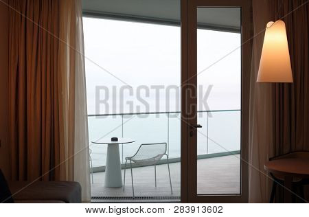 Living room with glass door to balcony. Sea view.