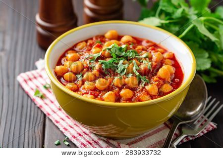 Spicy Chickpea Curry Chana Masala In Bowl On Dark Wooden Table