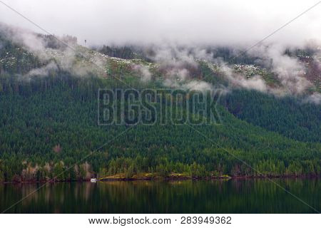 Morning fog in the mountains around Sproat lake in Vancouver Island, British Columbia, Canada