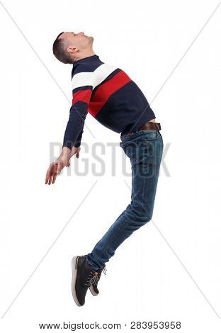 Side view of man in zero gravity or a fall. guy is flying, falling or floating in the air.  side view of person.  Isolated over white background. The guy is balancing on the toes of his fingers.