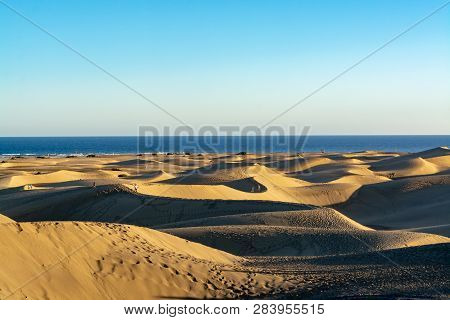 Landscape With Yellow Sandy Dunes Of Maspalomas And Blue Atlantic Ocean, Gran Canaria, Spain