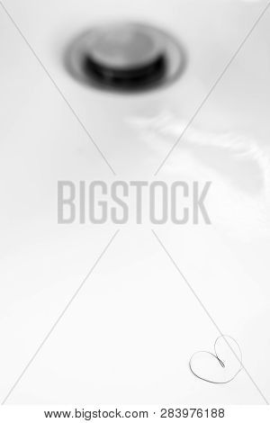 Heart-shaped Pubic Hair In A Sink Out Of Focus. Ideal For Concepts, Events And Backgrounds.
