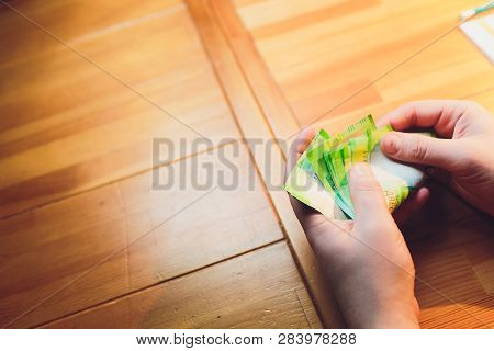 Russian Rubles In The Hand Of A Fan.male Hand Holding Many Of The Russian Banknotes.the Transfer Of 