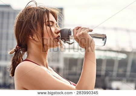 Little Break. Side View Of Young And Beautiful Woman Drinking Fresh Water After Active Morning Worko