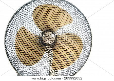 Household Fan In A Protective Mesh Casing In Bright Light