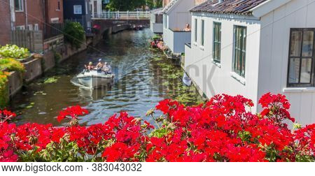 Panorama Of Red Flowers On The Bridge Over The Damsterdiep River In Appingedam, Netherlands