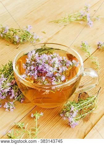 Cup Of Thyme Chaber Tea On White Wooden Background.shallow Dof.