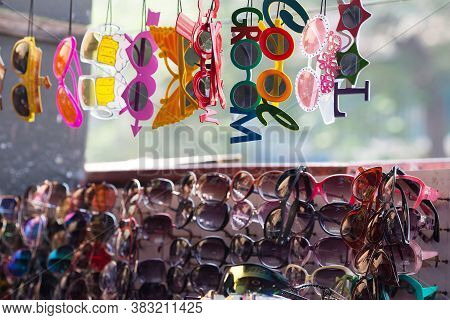 Various Cheep Colorful Sunglasses Being Sold In The Open Market Showcase. Oriental Bazaar
