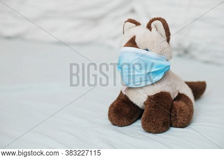 Cat Siamese With Medical Masks On Bed. Sicker Disease In Children. Coronovirus, Quarantine, Epidemic