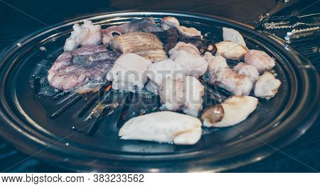 Close Up View Of Chitterlings With Mushrooms Being Fried At Korean Restaurant