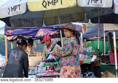 Yangon, Myanmar, Feb 24, 2019: Myanmese Woman With Thanakha (myanmar Powder) On Her Face And Wearing