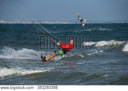 Kitesurfing on the waves of the sea in Mui Ne beach, Phan Thiet, Binh Thuan, Vietnam. Kitesurfing, Kiteboarding action photos. Kitesurf In Action 