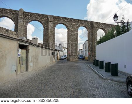 Street View On The Aqueduto Da Agua De Prata In Evora, Portugal. Aqueduct Of Silver Water.