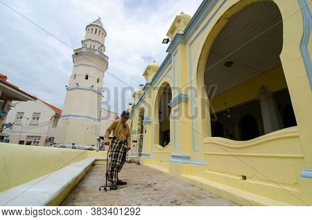 George Town, Penang/malaysia - Jul 19 2018: A Man Use Crutch Walk At Masjid Acheh.