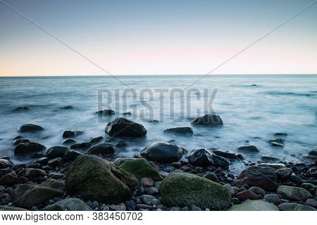 Scenic Long Exposure Close Up Of Rocky Baltic Sea Coast, Blue Evning On Ruegen Island
