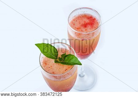 Cooling Rossini Italian Alcoholic Cocktail With Sparkling Wine, Strawberry Puree, Ice Cubes In Champ