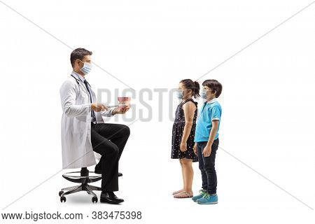 Dentist showing theeth brushing to a boy and girl with protective face masks isolated on white background