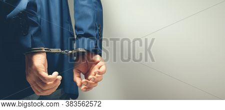 Man Hand Handcuffs In Backon Grey Background