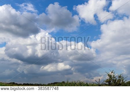 Beautiful Clouds In A Blue Sky In A Northern European Agriclutural Landscape