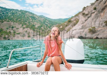 Little Girl Sailing On Boat In Clear Open Sea