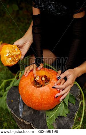 Daughter And Mother Hands Carving Pumpkin For Halloween, Prepares Jack Olantern