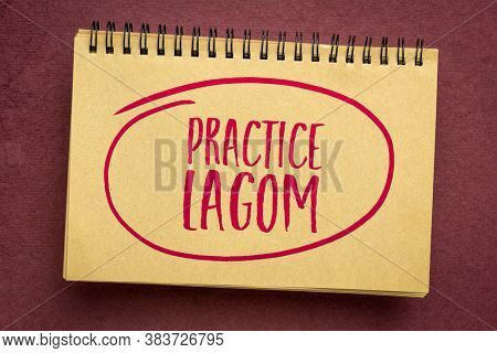 practice lagom - Swedish philosophy for a balanced life, handwriting in an art sketchbook, lifestyle concept