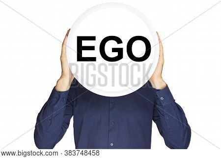 The Inscription Ego In Black Letters On A White Circle In The Hands Of A Man On A White Background.