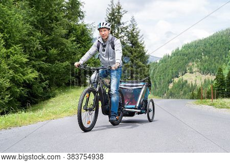 Man With E Bike Mtb And Kid Trailer Training