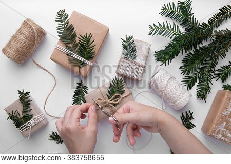 Hands Is Making Gifts For Christmas On White Background