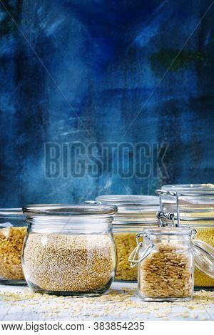 Assorted Cereals In Glass Jars: Kinoa, Bulgur, Couscous, Orzo, Brown Rice, Selective Focus