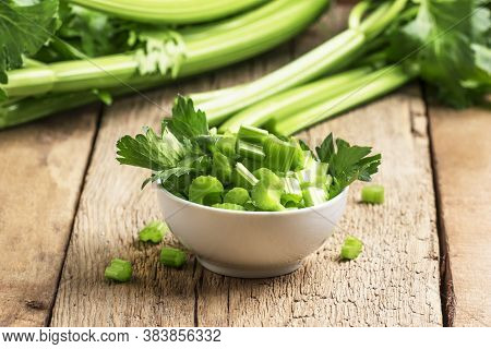 Fresh Sliced Celery In A White Bowl On A Vintage Wooden Background, Selective Focus