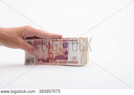 Hand Holds A Bundle Of Banknotes, Five Thousandth Bills On A White Background