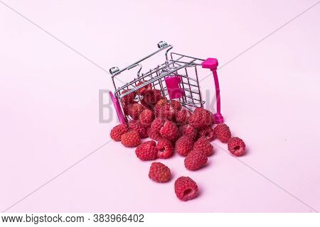 Metal Shopping Trolley Filled With Raspberry. Atural Fruit. Raspberries In A Small Shopping Trolley