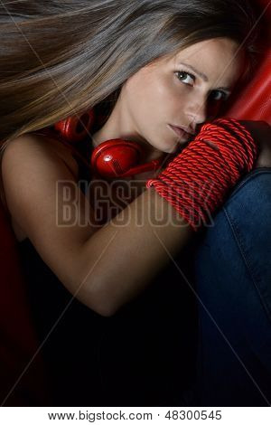 Een mooie jonge vrouw met de rode hoofdtelefoon