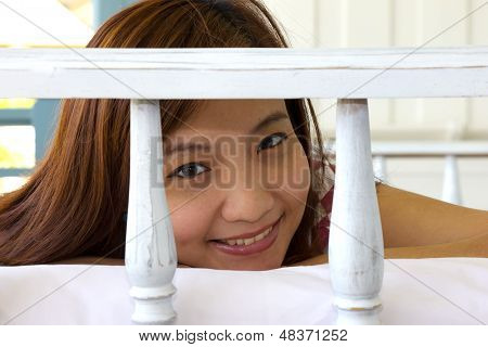 Closeup Happiness Woman's Face In Daybed At Balcony