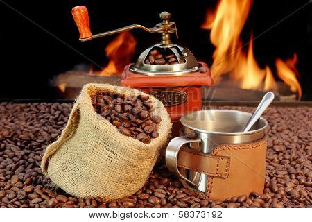 Stainless Steel Coffee Mug And Old Grinder With Beans