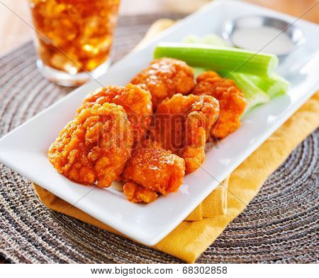 plate of boneless buffalo flavored chicken wings