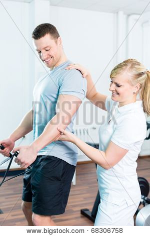 Patient at the physiotherapy doing physical exercises with Bowden cable 