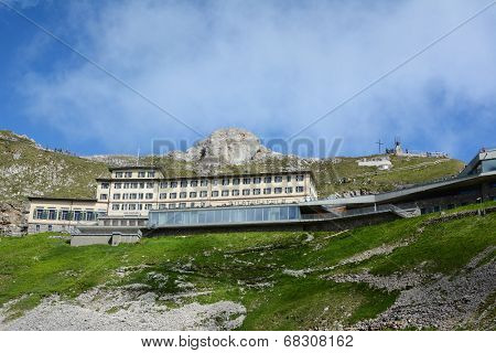 ALPNACHSTAD, SWITZERLAND - July 3, 2014: The Hotel Pilatus-Kulm, first opened in 1890, stands atop  Mount Pilatus in the Swiss Alps. Viewed from the Pilatus-Bahn cogwheel train.