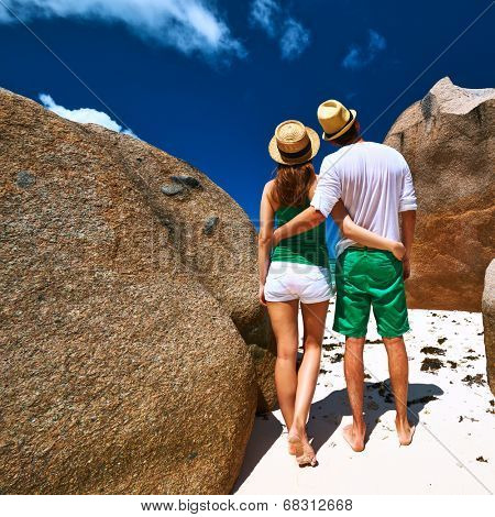 Couple in green on a tropical beach at Seychelles