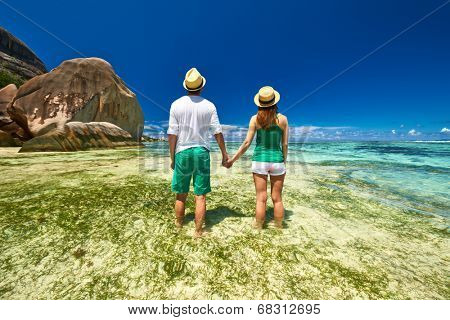 Couple in green on a tropical beach at Seychelles