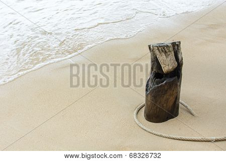 The Ship Ropes Twisted Around Log On Beach