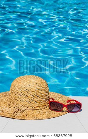 utensils for a nice and relaxing vacation day lying next to a swimming pool. relaxation on holiday.