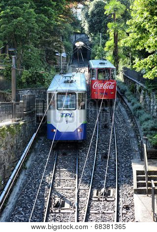 LUGANO, SWITZERLAND - JULY 5, 2014: Two funicular cars passing each other in Lugano. The Funicolare Lugano CittaÃ?ÃÂ ??Stazione is a short line connecting the Lugano railway station to the city center.