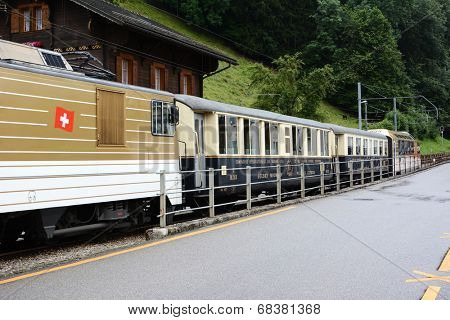 BROC, SWITZERLAND - JULY 8, 2014: The Chocolate Train at station. The vintage luxury tourist train departs from Montreux to stops in Gruyere and Broc for cheese and chocolate factory tours.